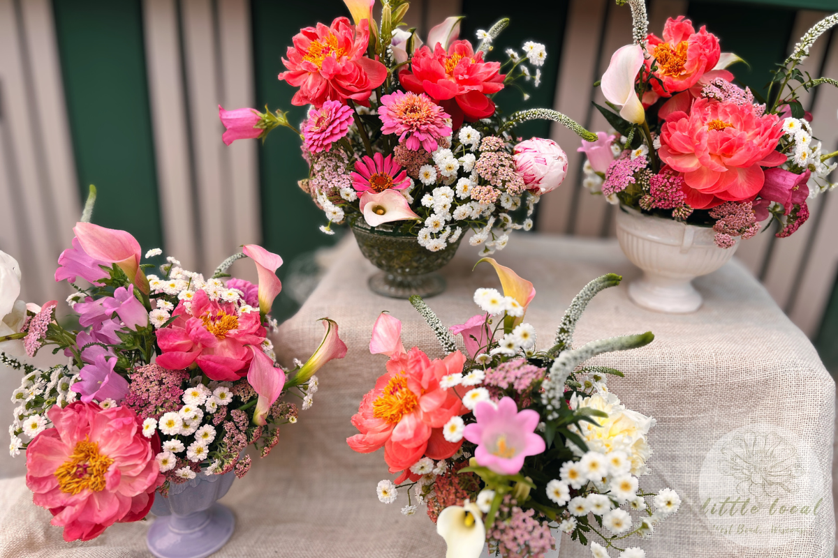 cheerful pink peonies in footed vase with green background